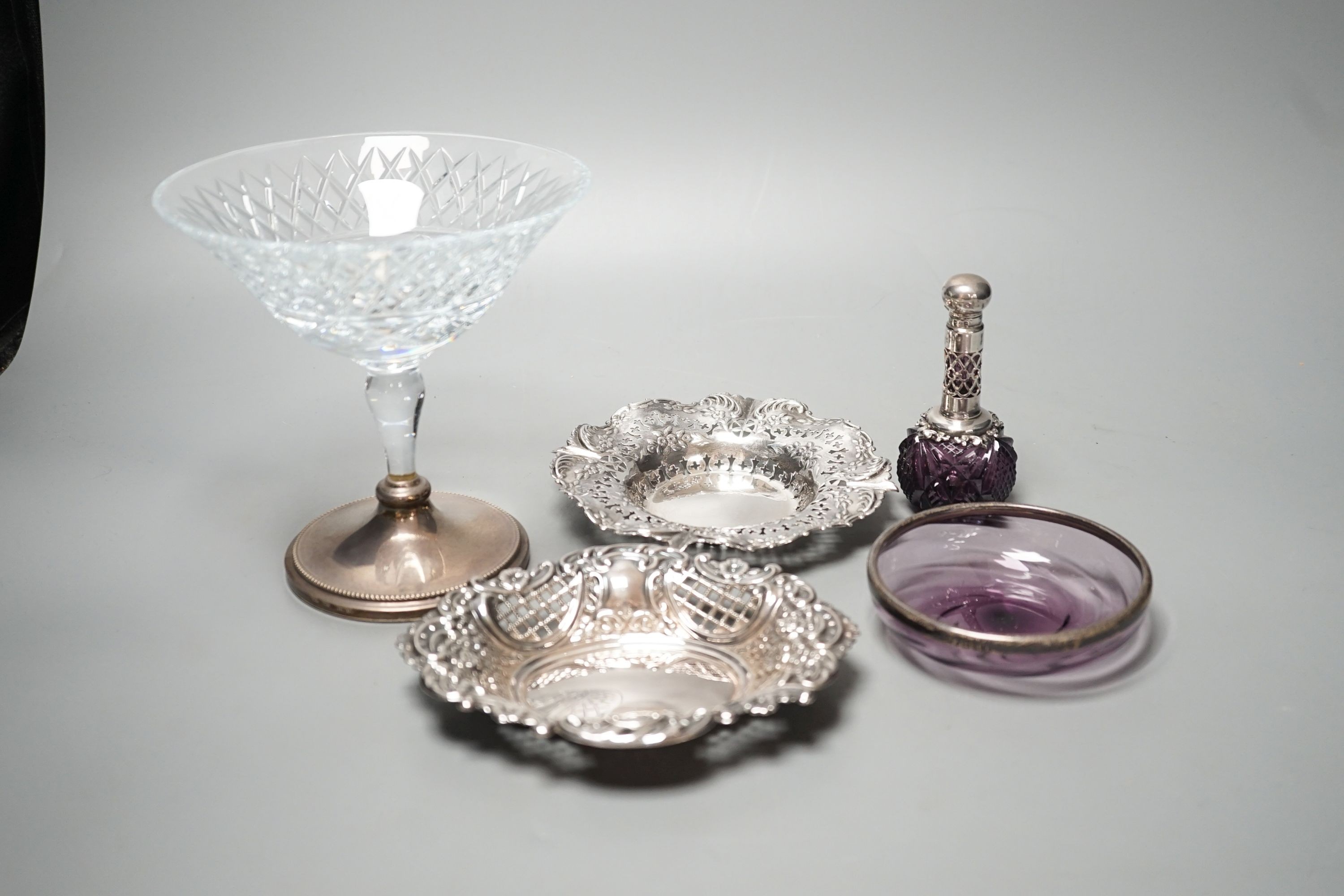 Two pierced silver trinket dishes, a late Victorian silver mounted amethyst glass dish, a similar scent flask and a silver mounted glass bowl.